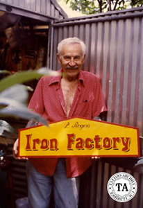 Paul Rogers holding The Iron Factory Sign